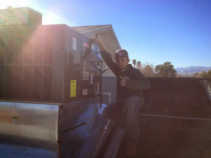 HVAC technician performing Boiler Repair on a rooftop unit in Santa Rosa